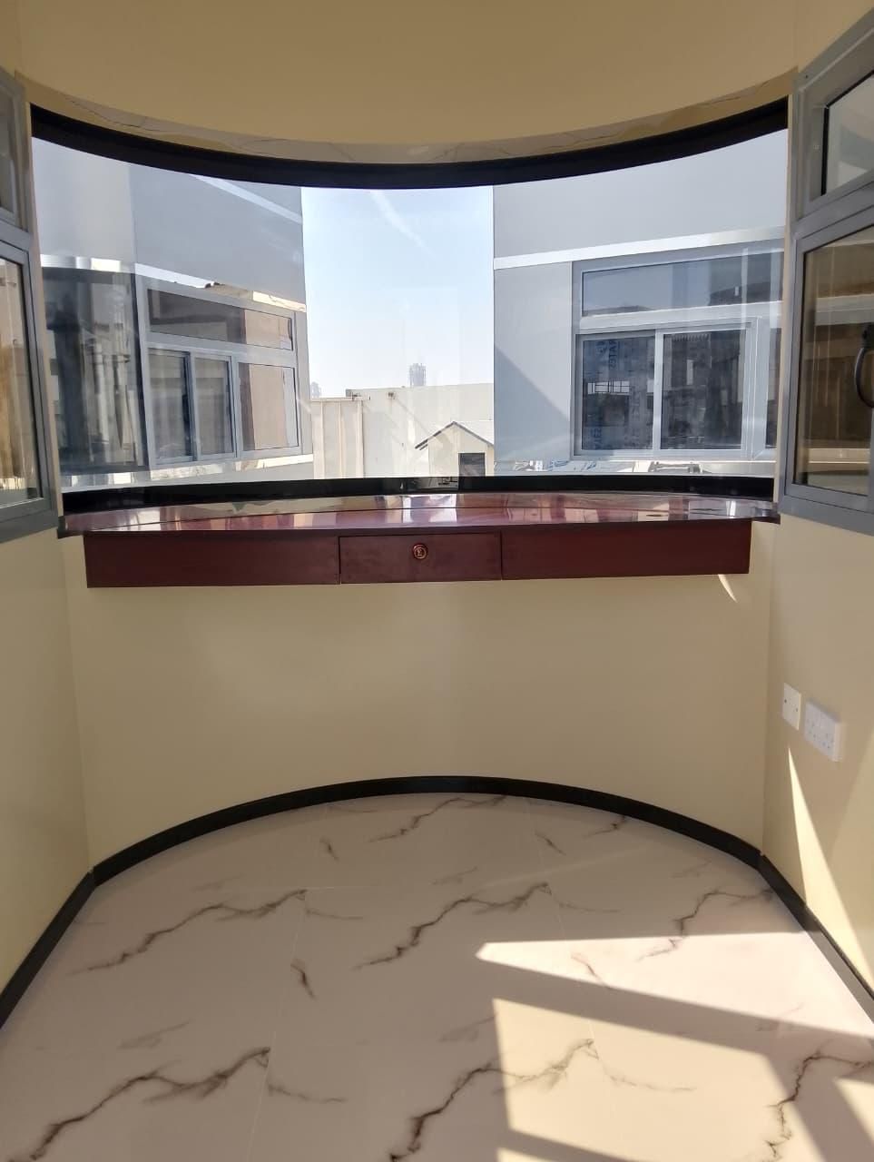 Interior with curved timber desk and marble effect tiling