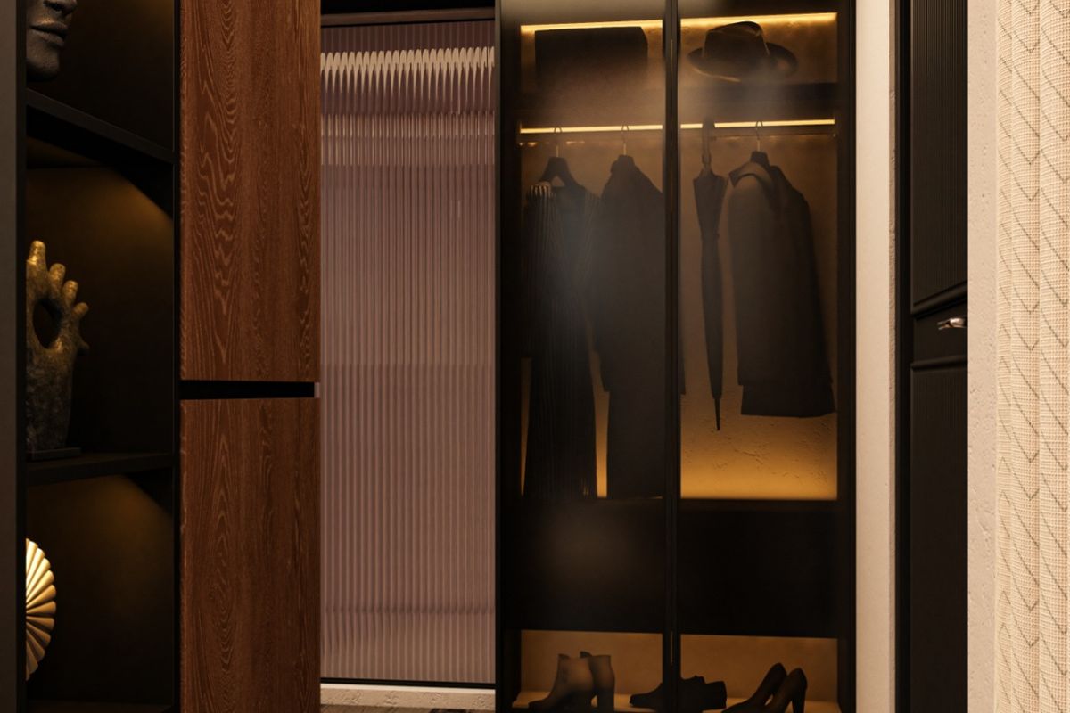 Walk-in wardrobe with lit glass fronts